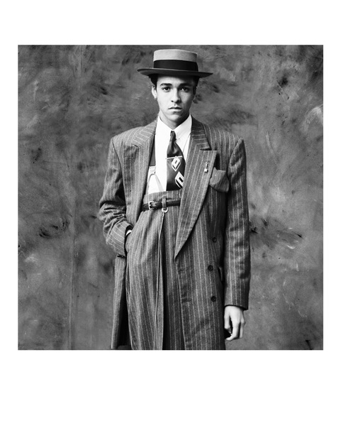 person in a large fitting suit