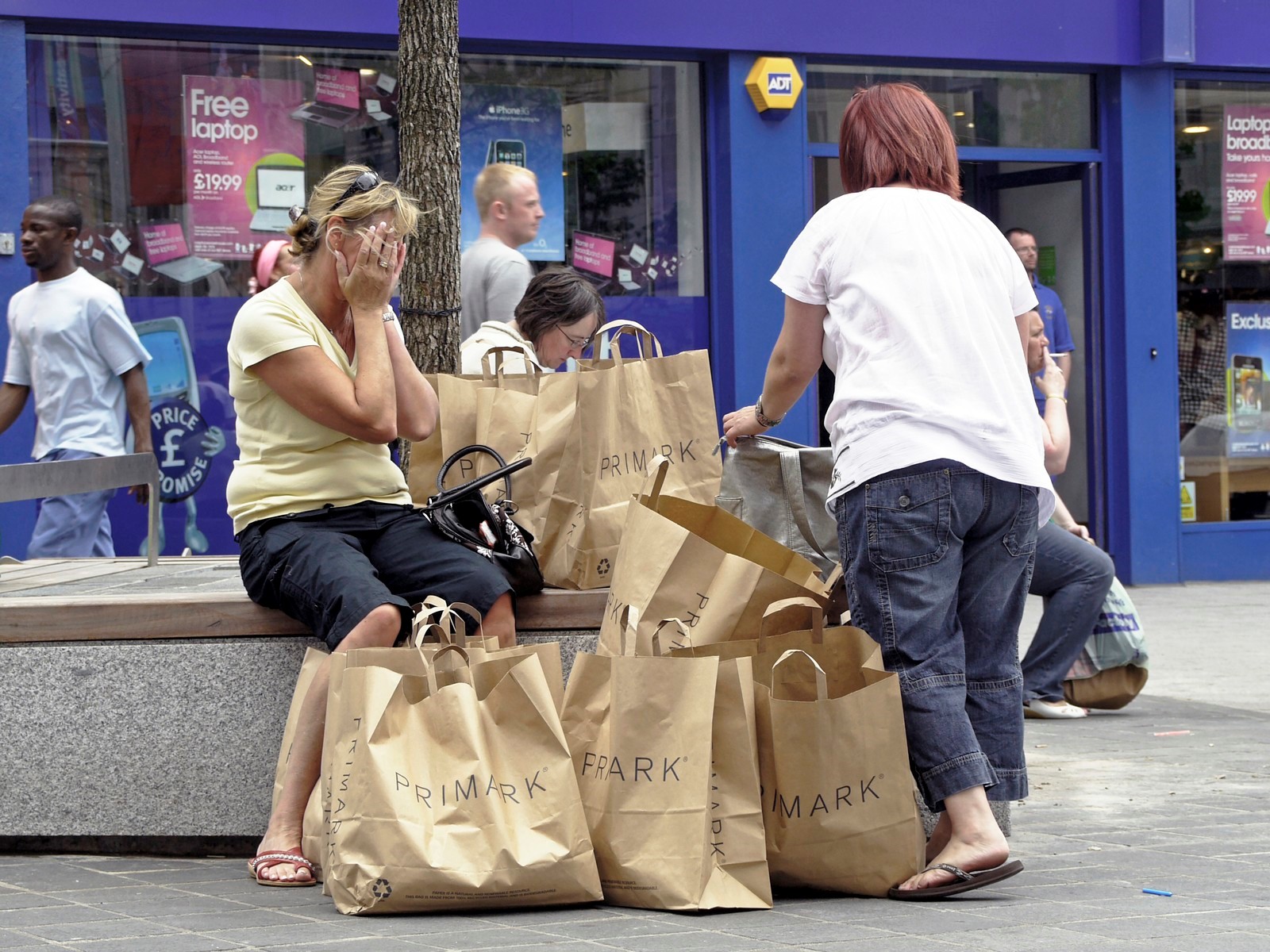 Scene of people shopping in a high street.
