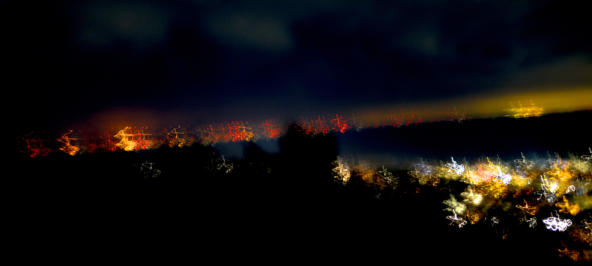 image of blurred lights in a dark landscape