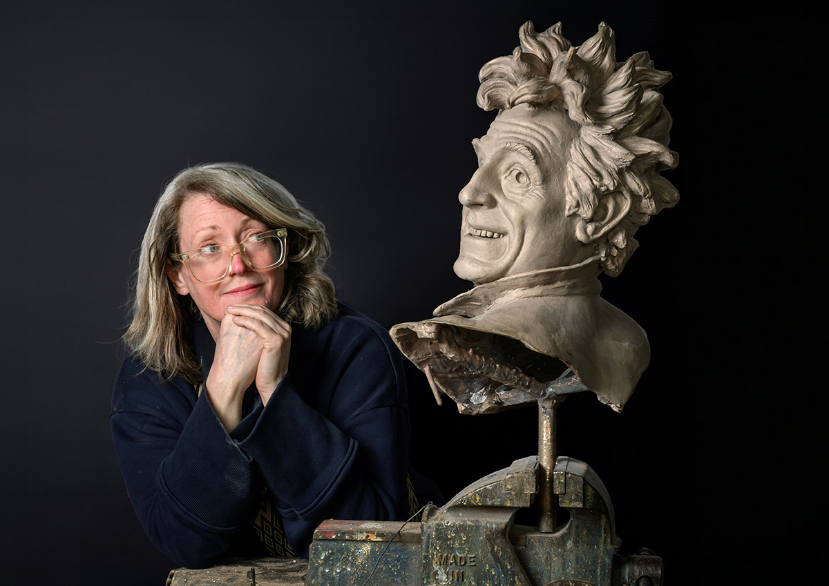 Sally Jones looking at a sculpted head depicting Terry.